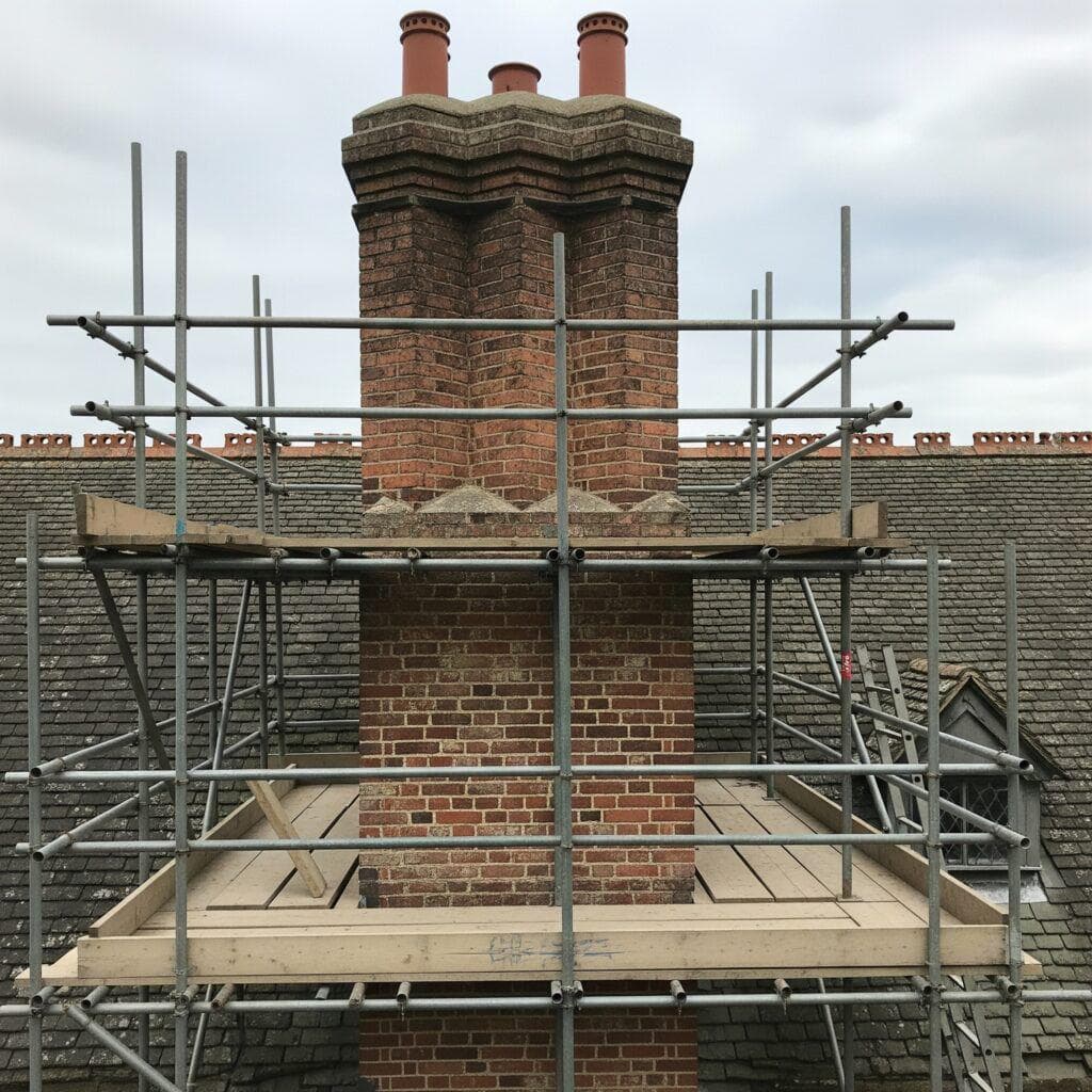 Chimney rebuild and restoration with scaffolding